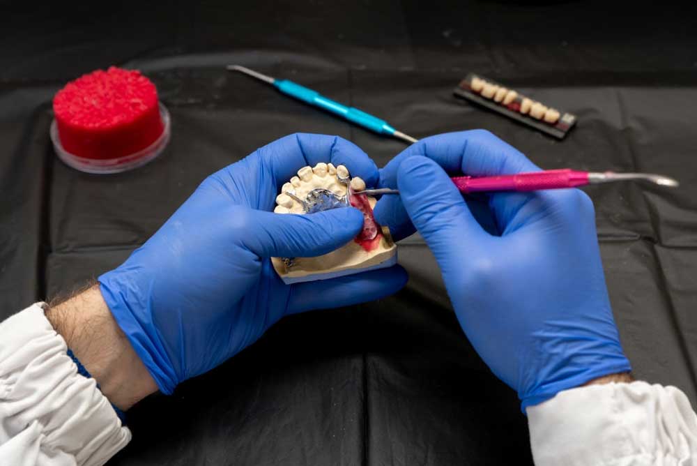 dentist making digital dentures in a laboratory