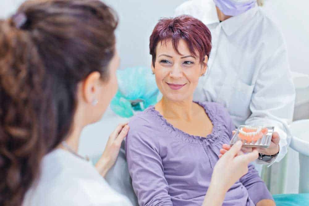 dentist showing digital dentures to a patient